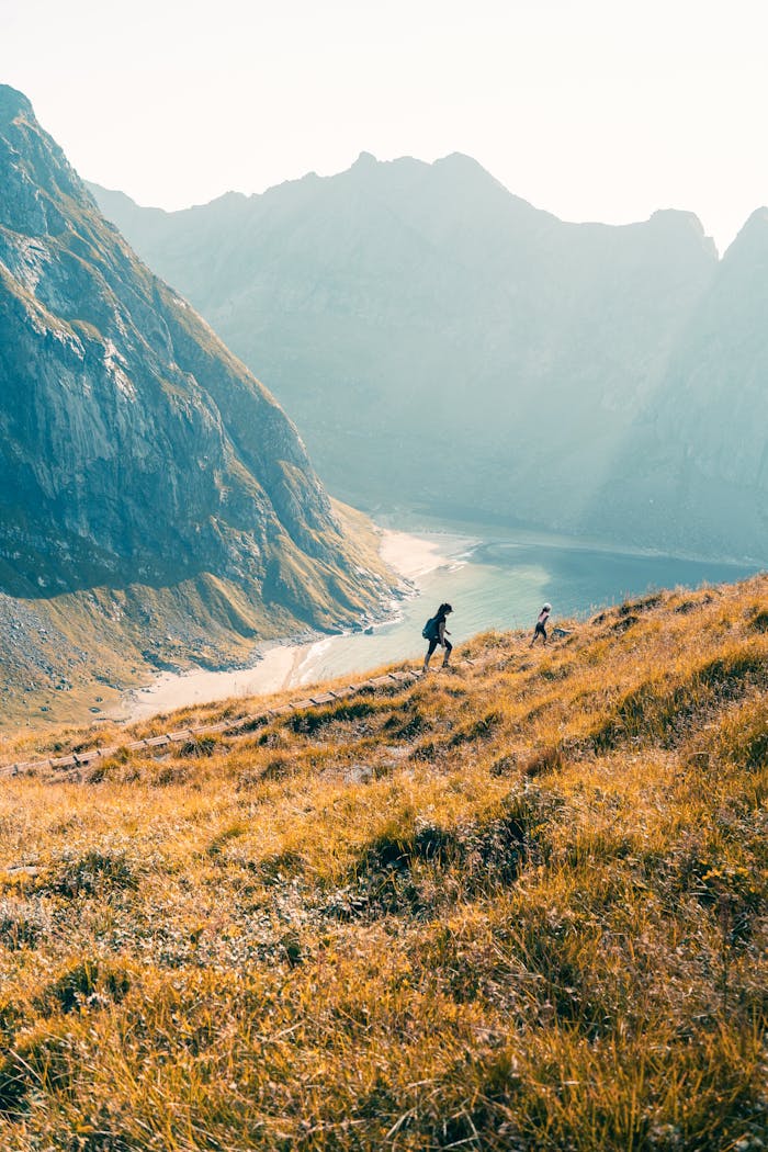 About Two hikers explore the stunning landscapes of Fredvang, Norway.